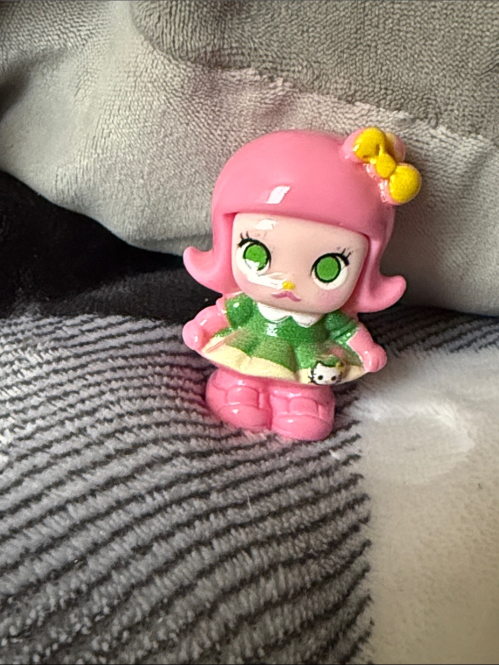 Pink Vinyl Doll Figurine with Green Dress and Yellow Bow